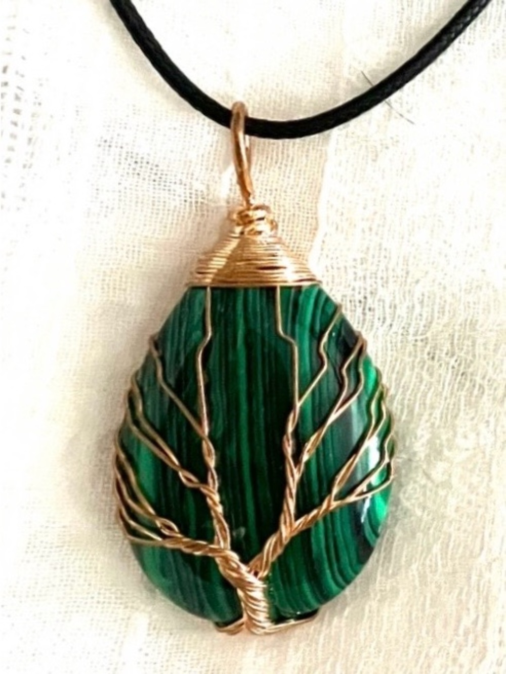 Tree of Life pendant necklace featuring a malachite stone & wire-wrapped design.